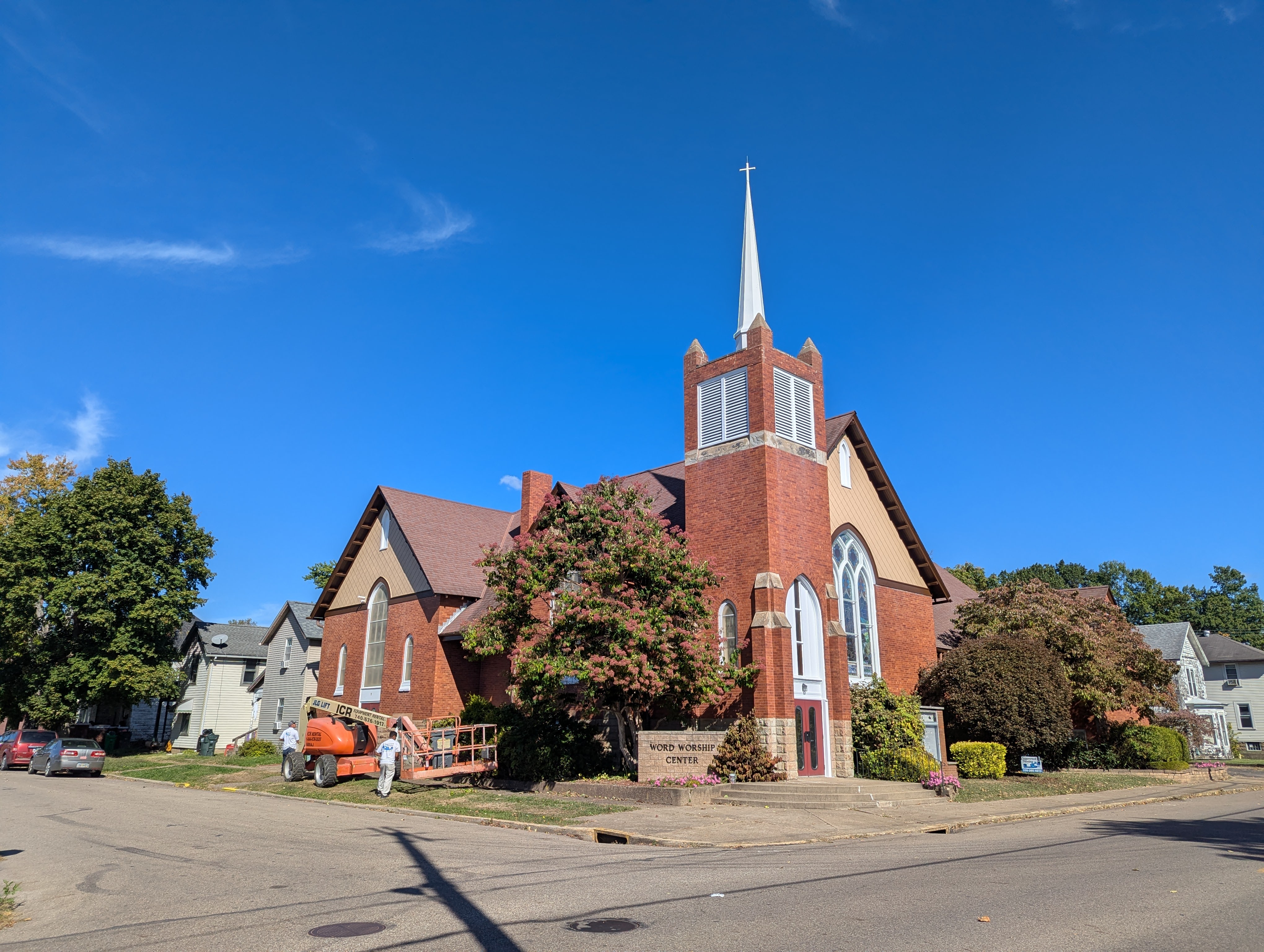Exterior of Word Worship Center church, with lift for painting restoration.