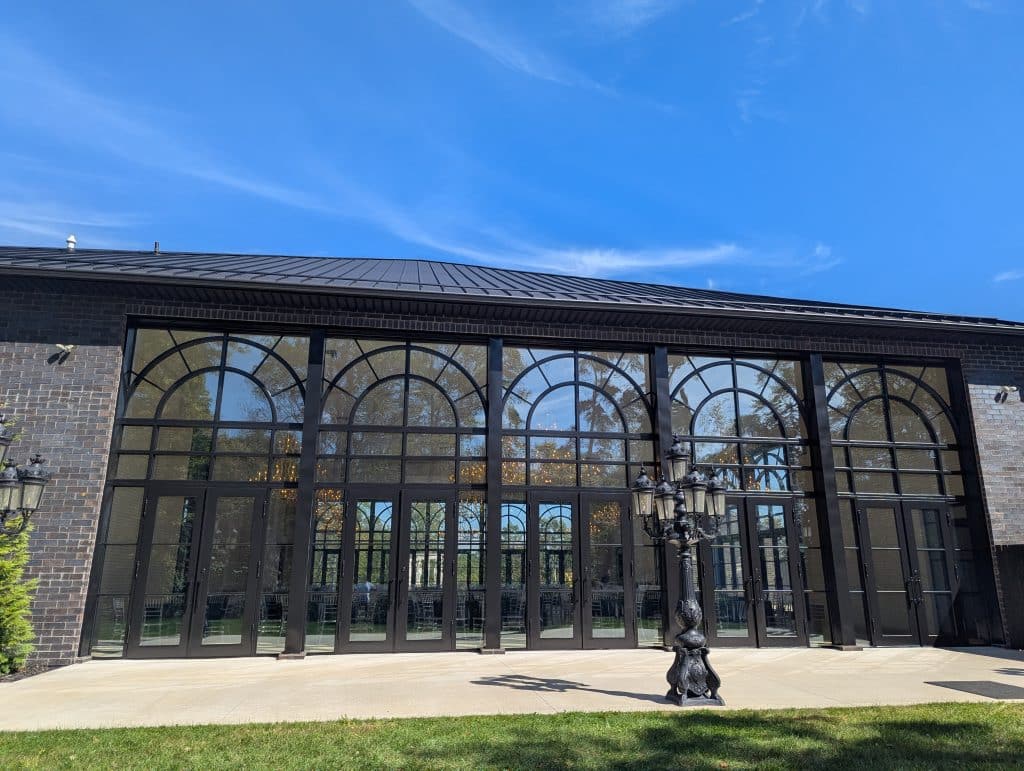 Building Arched Windows Black Trim Modern building with arched windows, black trim, and a decorative street lamp.